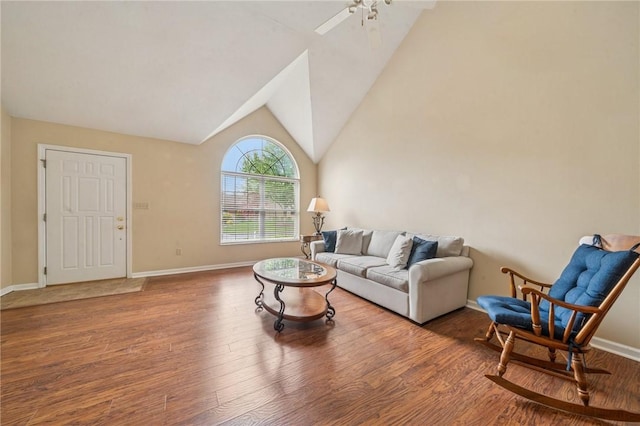living room with wood finished floors, lofted ceiling, ceiling fan, and baseboards