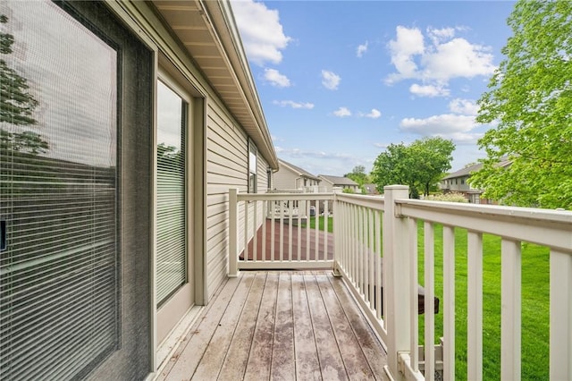 wooden terrace featuring a lawn