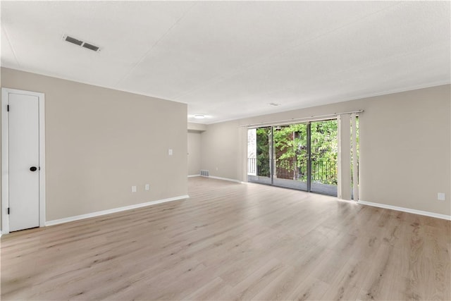 spare room featuring visible vents, baseboards, and light wood-style flooring