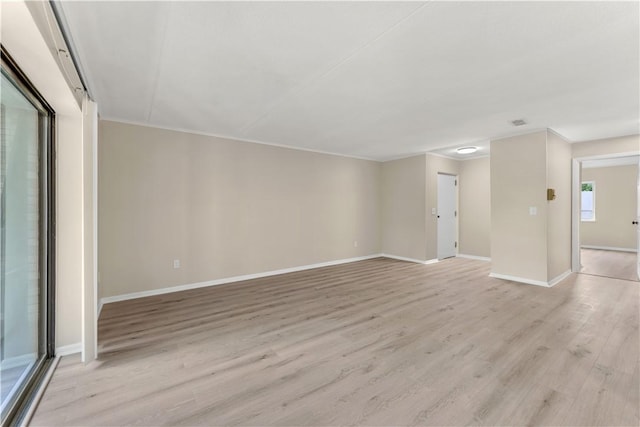 unfurnished living room featuring baseboards and light wood-style floors