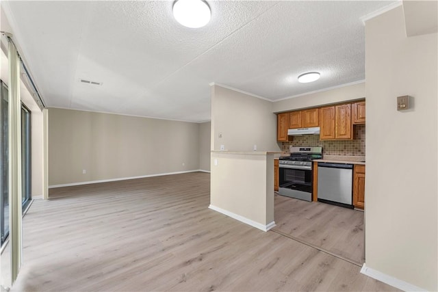 kitchen featuring light wood-style flooring, brown cabinets, stainless steel appliances, under cabinet range hood, and light countertops