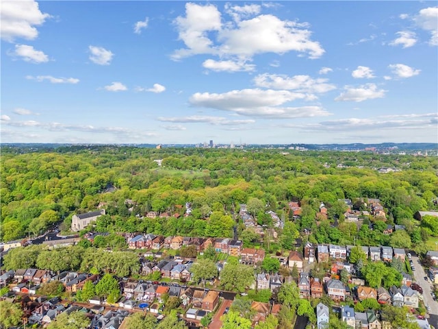drone / aerial view with a residential view and a view of trees