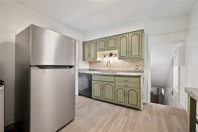 301 N Monroe St, City Of But Ne, PA 16001 - kitchen featuring freestanding refrigerator, black dishwasher, green cabinetry, and a sink