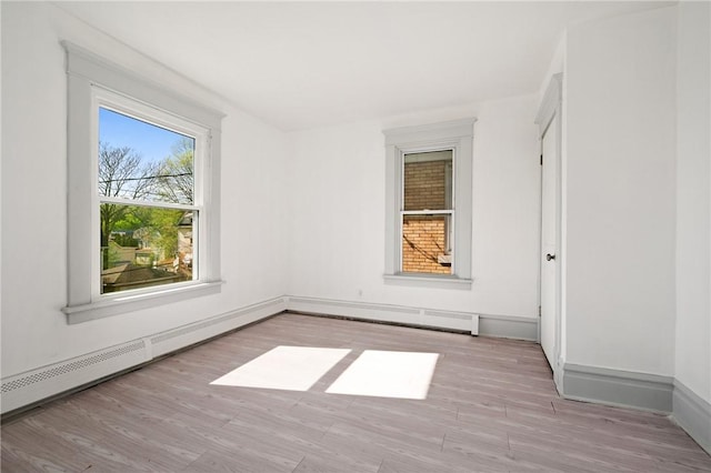 301 N Monroe St, City Of But Ne, PA 16001 - unfurnished room with wood finished floors, baseboards, and a baseboard heating unit