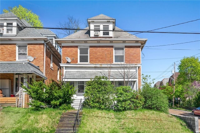 301 N Monroe St, City Of But Ne, PA 16001 - american foursquare style home featuring stairway, brick siding, and a front lawn
