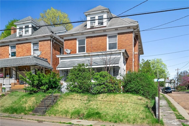 301 N Monroe St, City Of But Ne, PA 16001 - traditional style home featuring roof with shingles, a front lawn, and brick siding