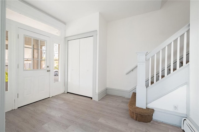 301 N Monroe St, City Of But Ne, PA 16001 - foyer featuring stairs, a baseboard radiator, and wood finished floors