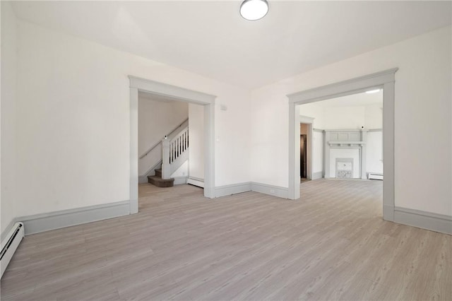 301 N Monroe St, City Of But Ne, PA 16001 - interior space with baseboards, baseboard heating, stairway, and light wood finished floors