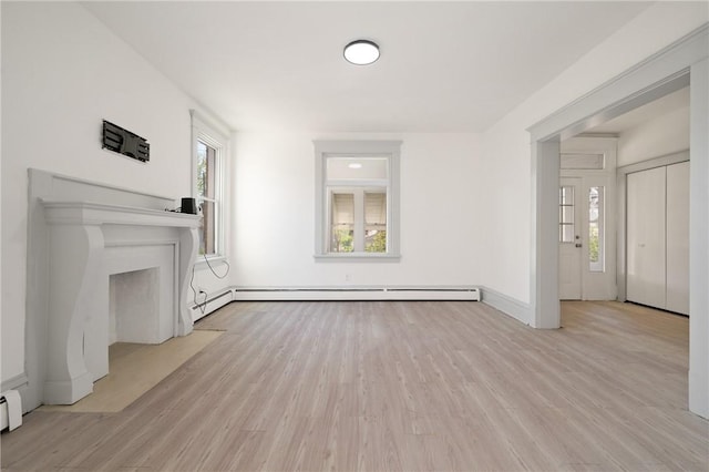 301 N Monroe St, City Of But Ne, PA 16001 - unfurnished living room featuring light wood finished floors, plenty of natural light, and a baseboard heating unit
