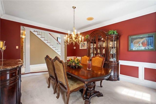 dining space featuring stairs, light carpet, an inviting chandelier, and crown molding