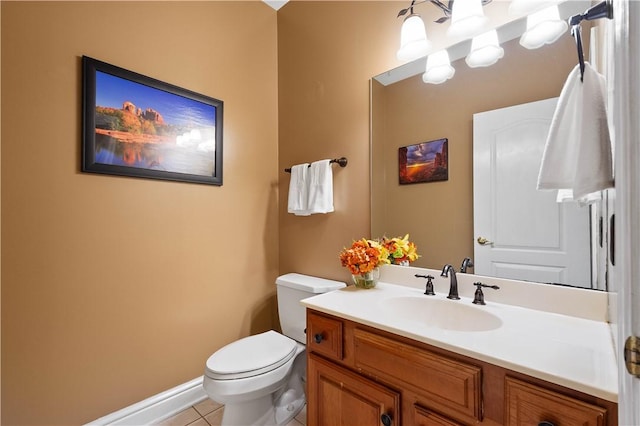 half bath featuring tile patterned flooring, toilet, baseboards, and vanity
