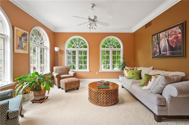 carpeted living room with baseboards, ceiling fan, crown molding, and visible vents