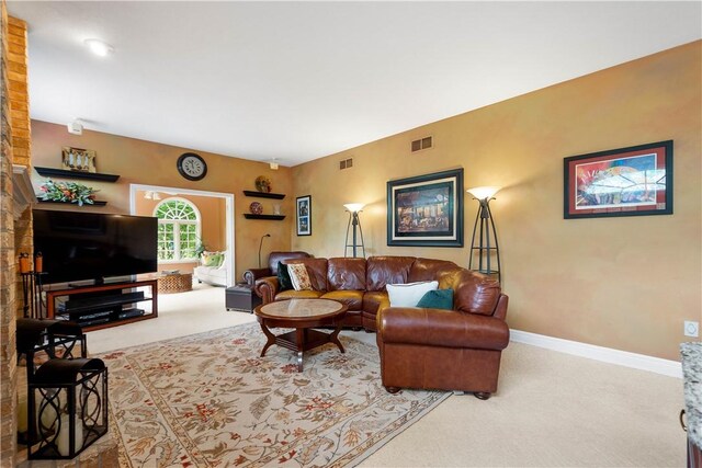living room with visible vents, baseboards, and carpet floors