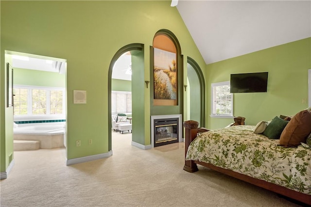 bedroom with multiple windows, high vaulted ceiling, baseboards, and carpet floors