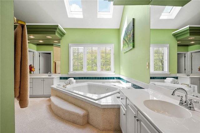 full bath featuring plenty of natural light, a sink, a skylight, and a whirlpool tub