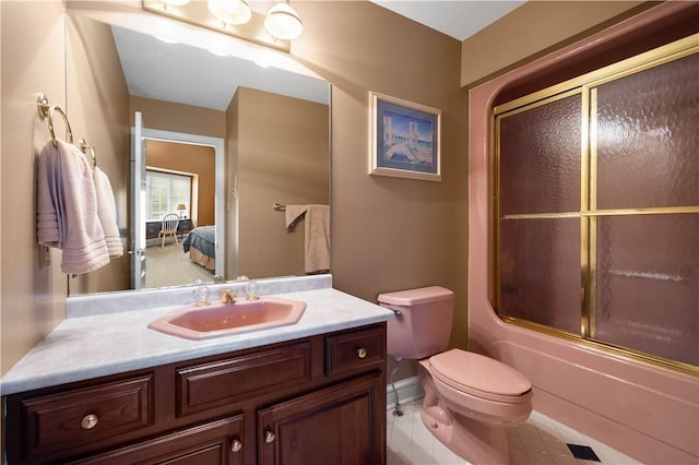 ensuite bathroom with toilet, vanity, ensuite bath, tile patterned floors, and enclosed tub / shower combo