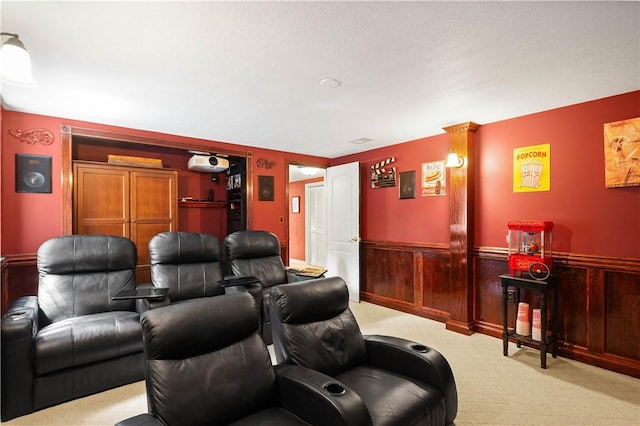 cinema room with wainscoting and carpet floors