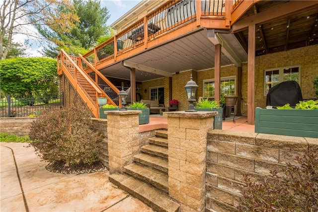 view of patio with stairs, a wooden deck, and fence
