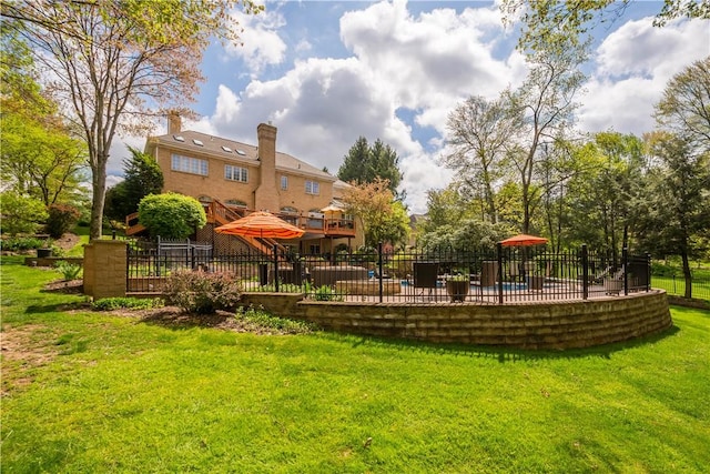 view of home's community with fence and a lawn