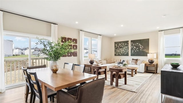 dining space with light wood-style floors and recessed lighting