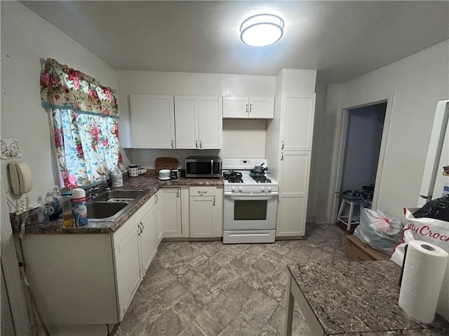 116 Ivy St, Wilkins Twp, PA 15145 - kitchen featuring stainless steel microwave, a sink, white cabinetry, white gas stove, and dark countertops