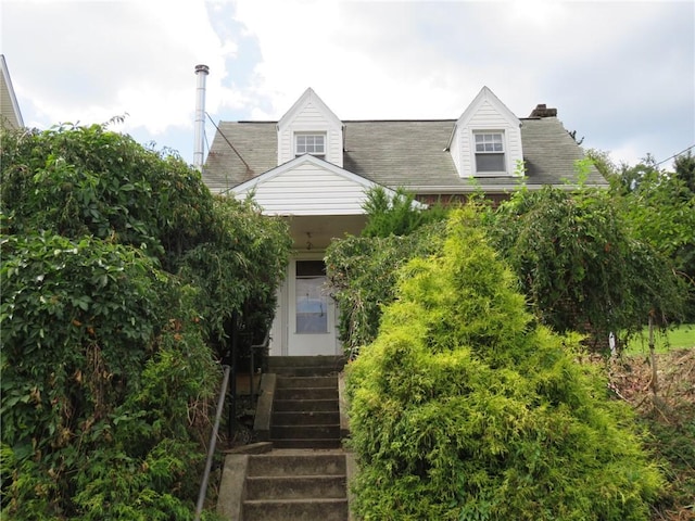 view of front facade featuring a chimney