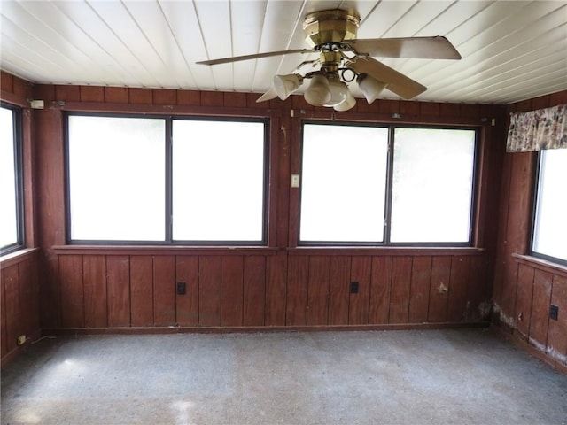 unfurnished sunroom with wooden walls