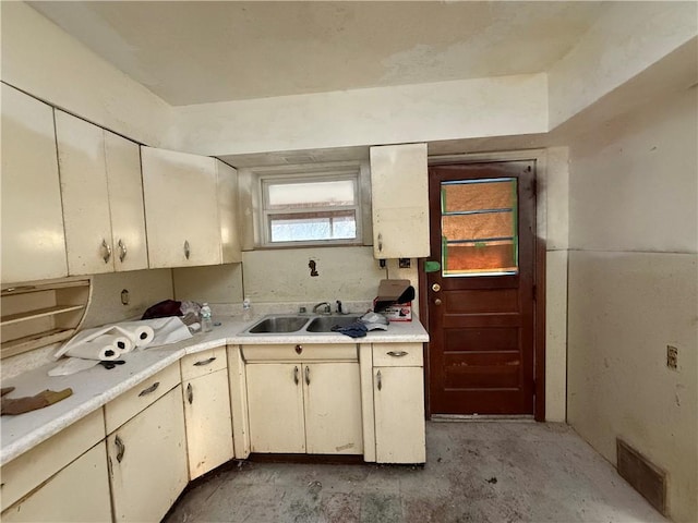 39 Eagle St, Fallowfield, PA 15022 - kitchen featuring a sink, water heater, visible vents, unfinished concrete floors, and light countertops