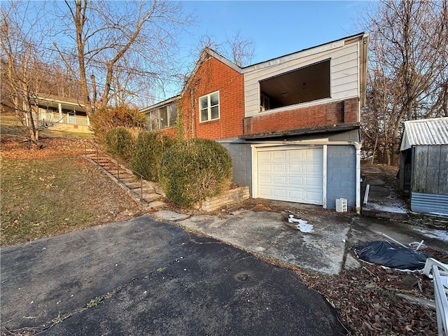 39 Eagle St, Fallowfield, PA 15022 - view of front of house featuring aphalt driveway and a garage