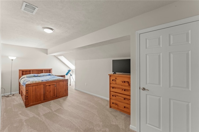 bedroom featuring visible vents, baseboards, and light carpet