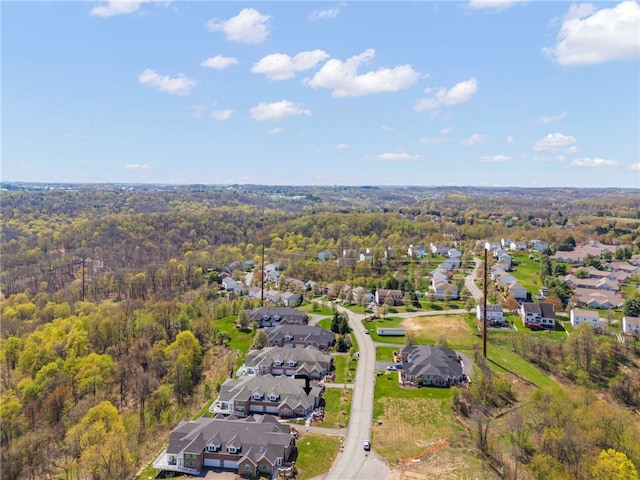 birds eye view of property with a forest view and a residential view