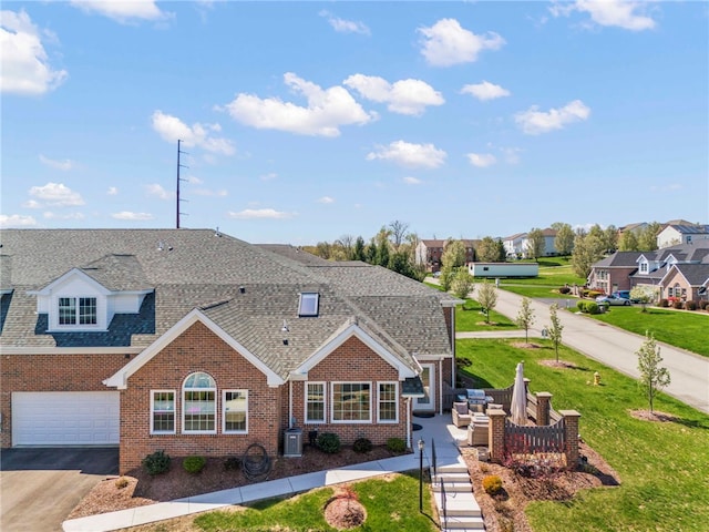 view of front of property with an attached garage, a residential view, aphalt driveway, a shingled roof, and brick siding