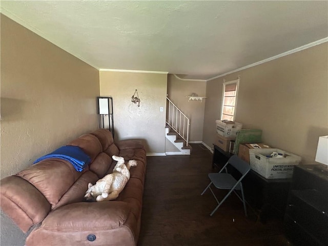 living area featuring wood finished floors, baseboards, ornamental molding, and stairs