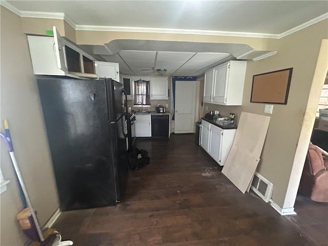 kitchen with ornamental molding, visible vents, dark wood-type flooring, black appliances, and white cabinets