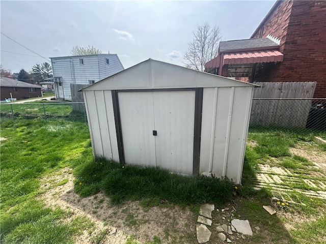view of shed featuring fence