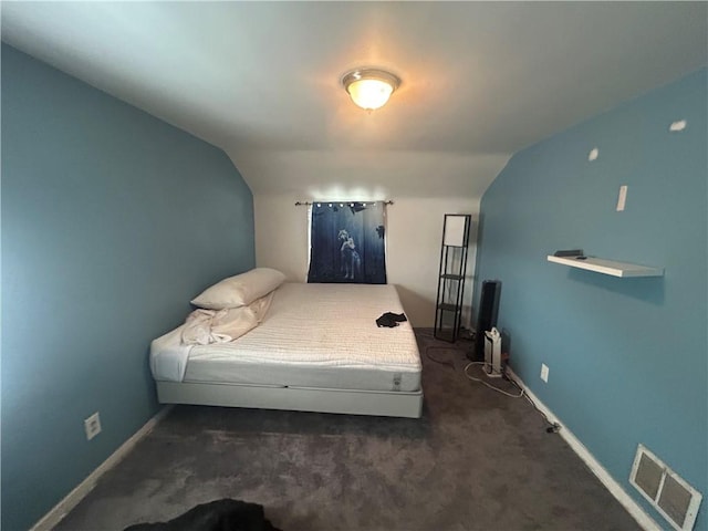 carpeted bedroom with lofted ceiling, baseboards, and visible vents