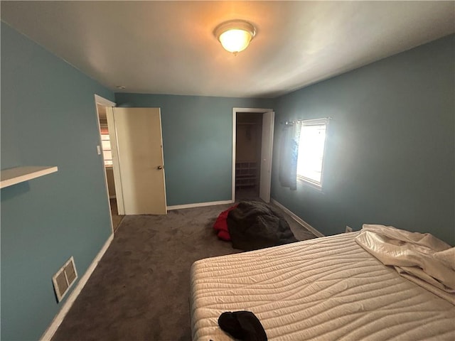 carpeted bedroom featuring a closet, baseboards, and visible vents