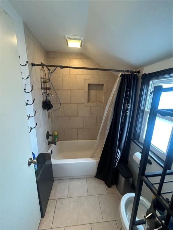 bathroom featuring toilet, tile patterned flooring, and shower / bath combo