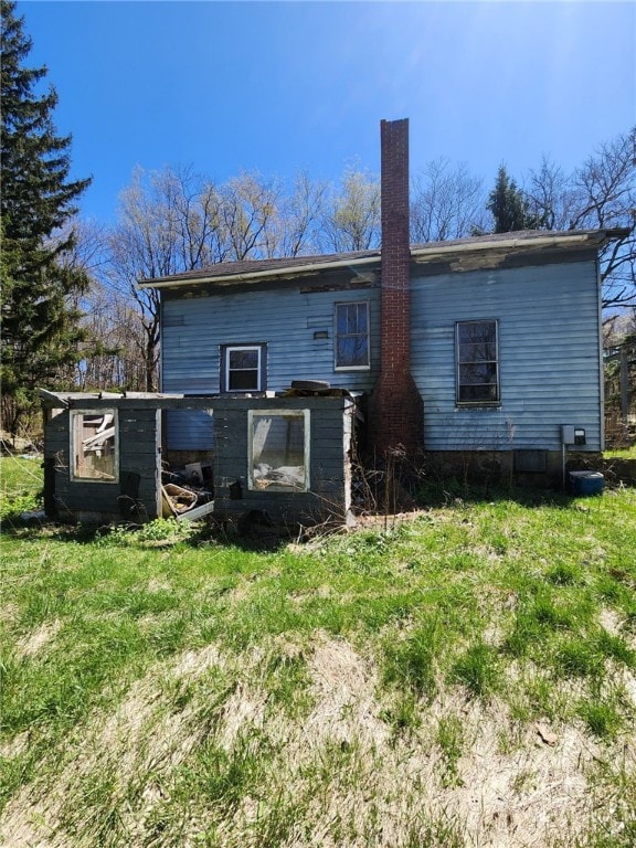 3324 Ridge Rd, Shade Twp, PA 15563 - rear view of house featuring a chimney, exterior structure, and an outbuilding