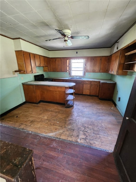3324 Ridge Rd, Shade Twp, PA 15563 - kitchen with a peninsula, brown cabinetry, a ceiling fan, and wood-type flooring