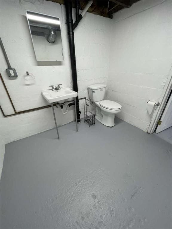 846 Neely Heights Ave, Coraopolis, PA 15108 - half bathroom featuring toilet, a sink, concrete block wall, and concrete flooring
