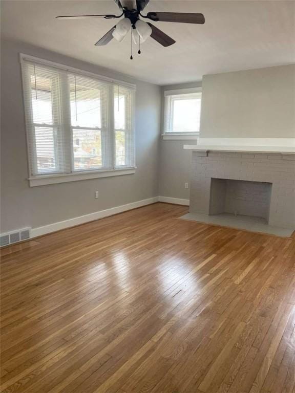 846 Neely Heights Ave, Coraopolis, PA 15108 - unfurnished living room with wood finished floors, a ceiling fan, a fireplace, visible vents, and baseboards