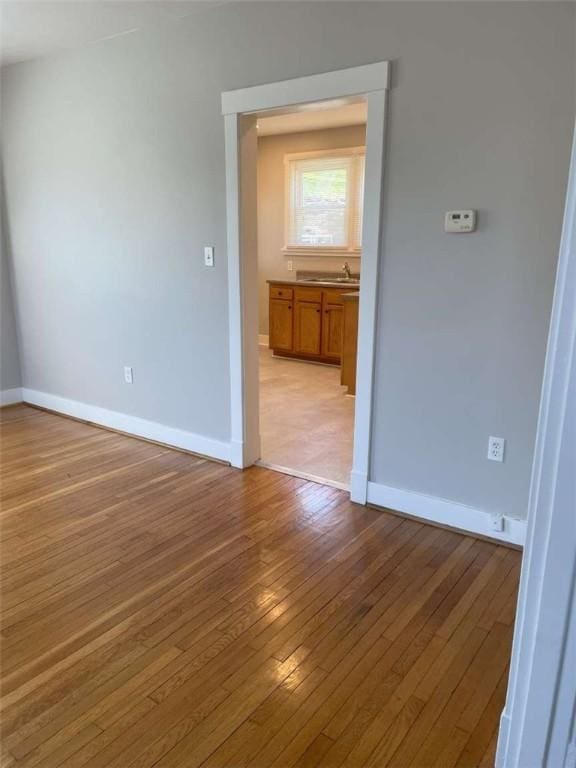846 Neely Heights Ave, Coraopolis, PA 15108 - spare room featuring baseboards, wood-type flooring, and a sink