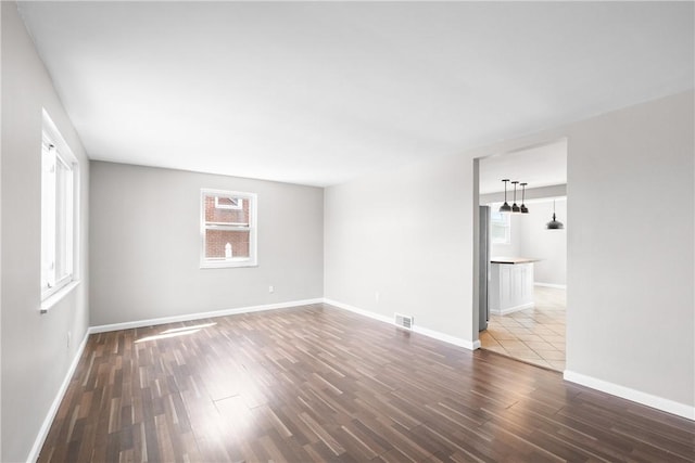 3606 Churchview Ave, Baldwin Boro, PA 15236 - unfurnished living room with baseboards, a wealth of natural light, visible vents, and dark wood-style flooring