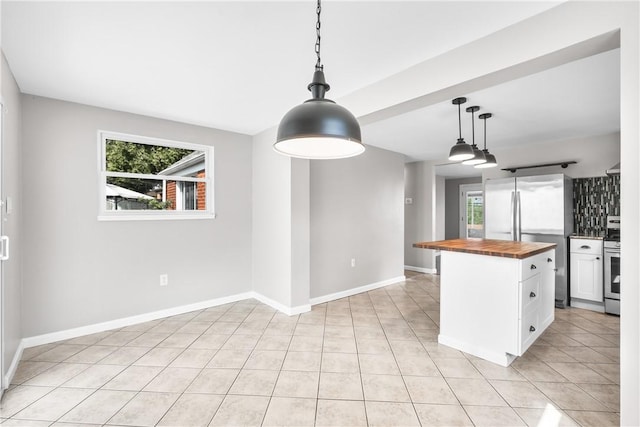 3606 Churchview Ave, Baldwin Boro, PA 15236 - kitchen with wooden counters, white cabinets, baseboards, decorative light fixtures, and appliances with stainless steel finishes