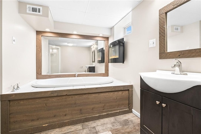 3606 Churchview Ave, Baldwin Boro, PA 15236 - bathroom featuring a garden tub, visible vents, and vanity