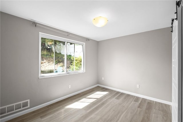 3606 Churchview Ave, Baldwin Boro, PA 15236 - empty room featuring baseboards, a barn door, visible vents, and wood finished floors