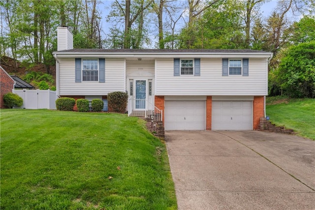 5993 Monongahela Ave, Bethel Park, PA 15102 - split foyer home with an attached garage, fence, a chimney, concrete driveway, and brick siding