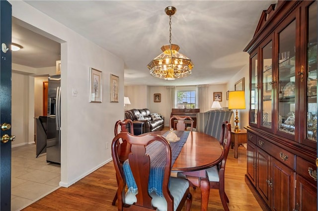 5993 Monongahela Ave, Bethel Park, PA 15102 - dining space featuring a chandelier, baseboards, and light wood-type flooring