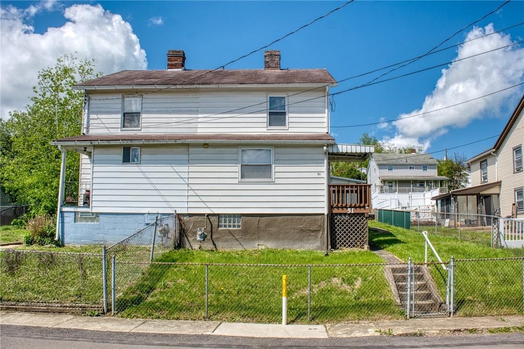 exterior space with a yard, a chimney, and fence private yard